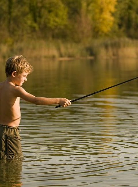 Niño pescando en un estanque
